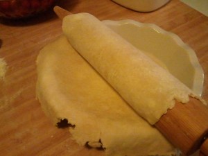 Gently roll the dough around the rolling pin, bring it to the pie plate, then unroll the dough.