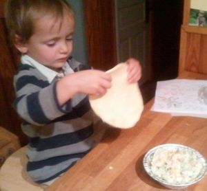 The dough stretches a little bit, but not too much. It fits nicely over the bitty pot pie. Once the rims are egg-washed, it’s a matter of laying the dough on top and crimping the edges shut.