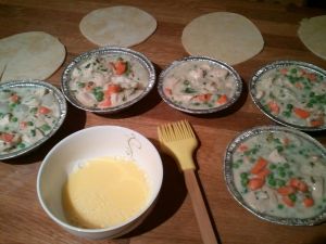 This is the chicken filling. Fill one pie to see how much you want it filled, then stick with that amount for each pie. While the dough rests before its second re-roll, go ahead and egg-wash the rims of the pie plates and finish the pies.
