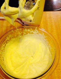 The whipped cream is just clinging to the beaters, and there's a soft little peak down in the bowl.