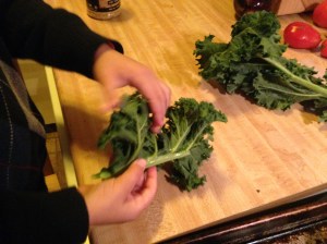 Tear the leaves downward away from the stalk.